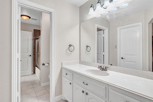 1217 Kent Brown Rd, Garland, TX 75044 - bathroom with tile patterned flooring, vanity, shower / bath combination with glass door, toilet, and baseboards