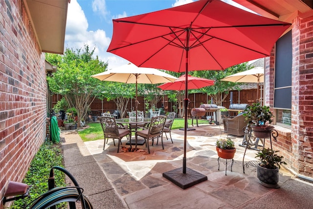 1217 Kent Brown Rd, Garland, TX 75044 - fenced backyard with outdoor dining area and a patio