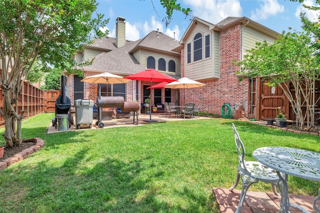 1217 Kent Brown Rd, Garland, TX 75044 - back of house featuring brick siding, a patio, roof with shingles, and a chimney