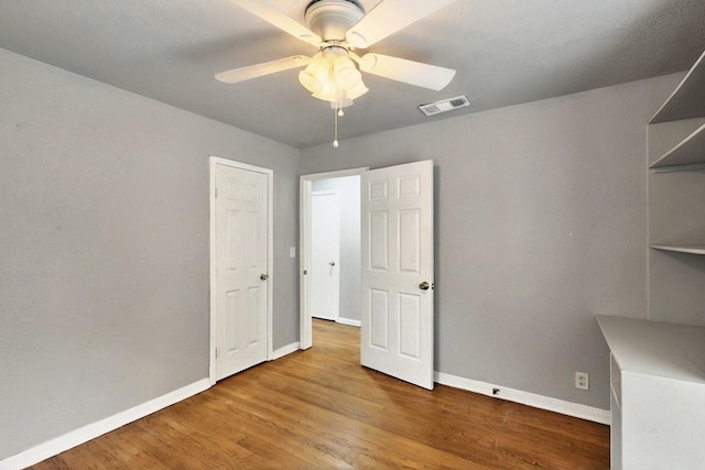 3617 Willing Ave, Fort Worth, TX 76110 - unfurnished bedroom featuring baseboards, wood finished floors, and a ceiling fan