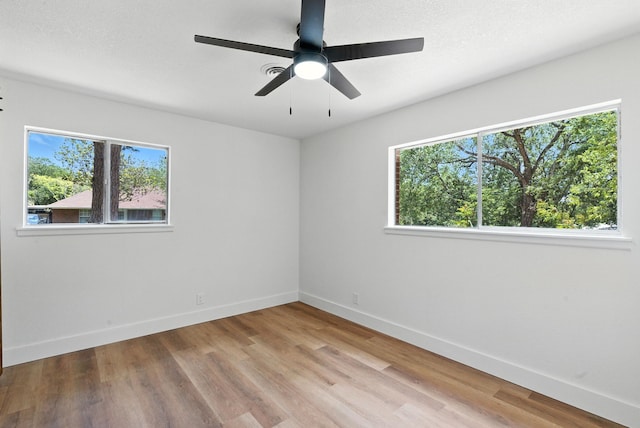 1423 W Ball St, Weatherford, TX 76086 - unfurnished room featuring plenty of natural light, light wood-style floors, and a ceiling fan