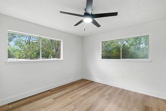1423 W Ball St, Weatherford, TX 76086 - unfurnished room featuring plenty of natural light, light wood-style floors, and a ceiling fan