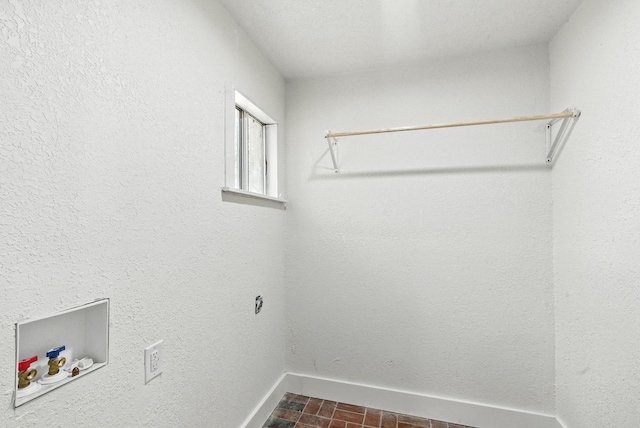 1423 W Ball St, Weatherford, TX 76086 - washroom with hookup for a washing machine and brick patterned flooring