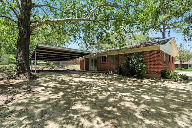 1423 W Ball St, Weatherford, TX 76086 - view of front facade featuring french doors, a carport, brick siding, and driveway