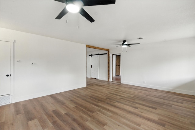 1423 W Ball St, Weatherford, TX 76086 - unfurnished room with ceiling fan, wood finished floors, and a barn door