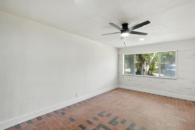 1423 W Ball St, Weatherford, TX 76086 - spare room with brick patterned flooring, ceiling fan, and a textured ceiling