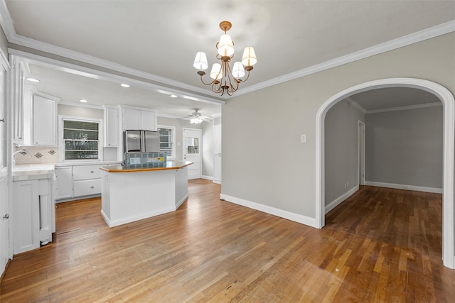 2530 Colcord, Waco, TX 76707 - kitchen with freestanding refrigerator, arched walkways, tasteful backsplash, white cabinetry, and ceiling fan