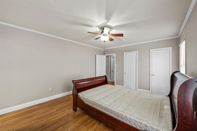 2530 Colcord, Waco, TX 76707 - bedroom with wood finished floors, baseboards, a ceiling fan, ornamental molding, and two closets