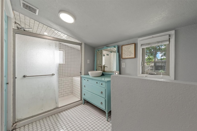 2530 Colcord, Waco, TX 76707 - bathroom featuring a stall shower, a textured ceiling, and vanity
