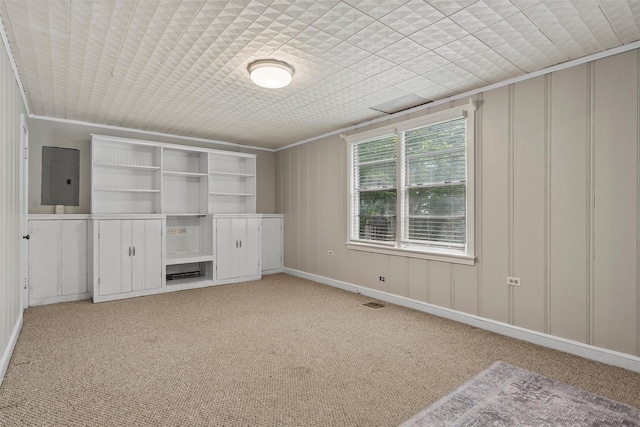 2530 Colcord, Waco, TX 76707 - unfurnished bedroom featuring electric panel, light carpet, a decorative wall, and ornamental molding