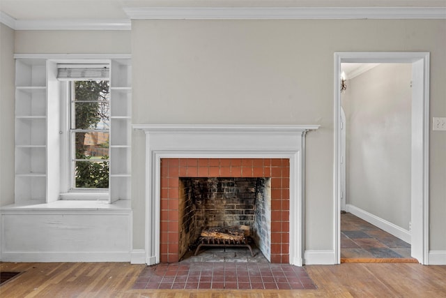 2530 Colcord, Waco, TX 76707 - detailed view of a tiled fireplace, crown molding, wood finished floors, and baseboards