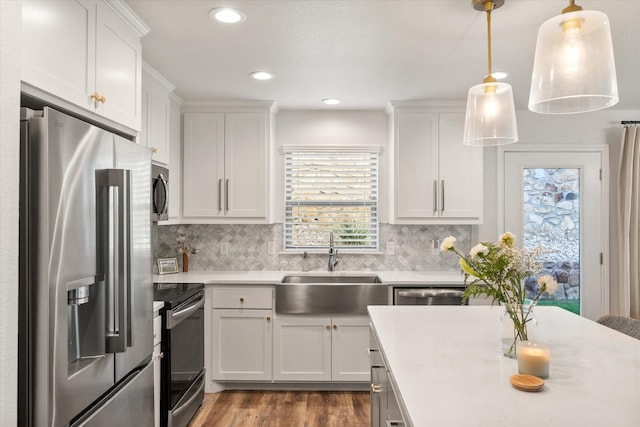 1321 Thistle Hill Trl, Weatherford, TX 76087 - kitchen featuring stainless steel appliances, a sink, light countertops, white cabinets, and recessed lighting