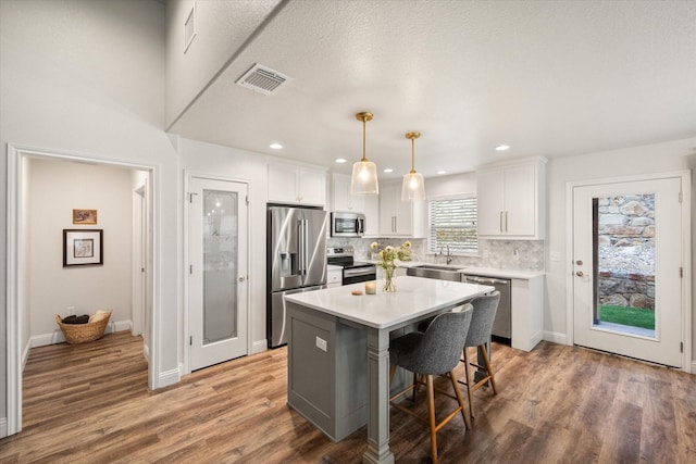 1321 Thistle Hill Trl, Weatherford, TX 76087 - kitchen featuring appliances with stainless steel finishes, a sink, light countertops, white cabinetry, and recessed lighting