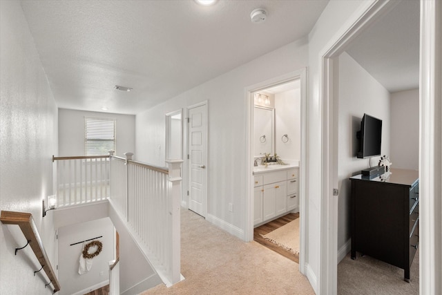 1321 Thistle Hill Trl, Weatherford, TX 76087 - corridor featuring an upstairs landing, light colored carpet, and baseboards