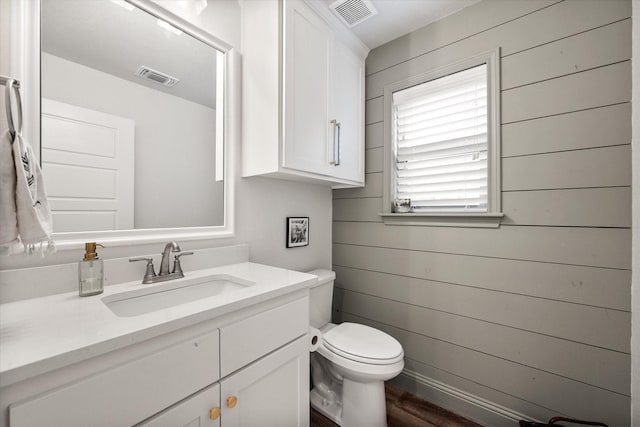 1321 Thistle Hill Trl, Weatherford, TX 76087 - bathroom with toilet, vanity, wooden walls, and wood finished floors