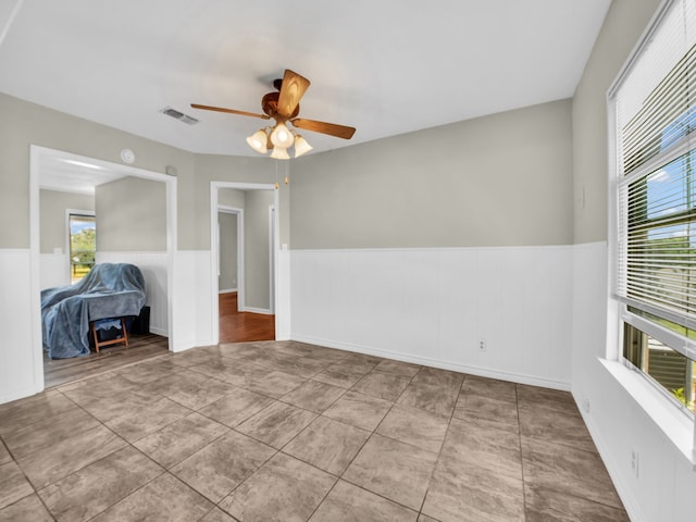 323 W Rentz St, Weatherford, TX 76086 - empty room with wainscoting and ceiling fan
