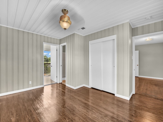323 W Rentz St, Weatherford, TX 76086 - unfurnished bedroom featuring ornamental molding, wood finished floors, a closet, and baseboards