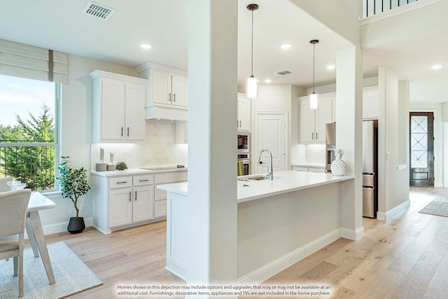 401 Sparrow Dr, Wylie, TX 75098 - kitchen with a sink, light wood finished floors, stainless steel fridge with ice dispenser, decorative backsplash, and recessed lighting
