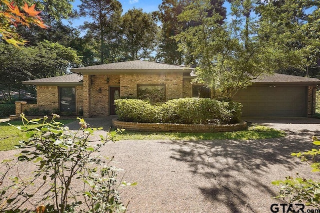 641 Hideaway Ln E, Hideaway, TX 75771 - view of front of property featuring brick siding, a garage, and asphalt driveway