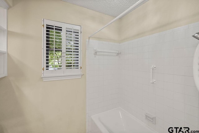 641 Hideaway Ln E, Hideaway, TX 75771 - bathroom featuring bathing tub / shower combination and a textured ceiling