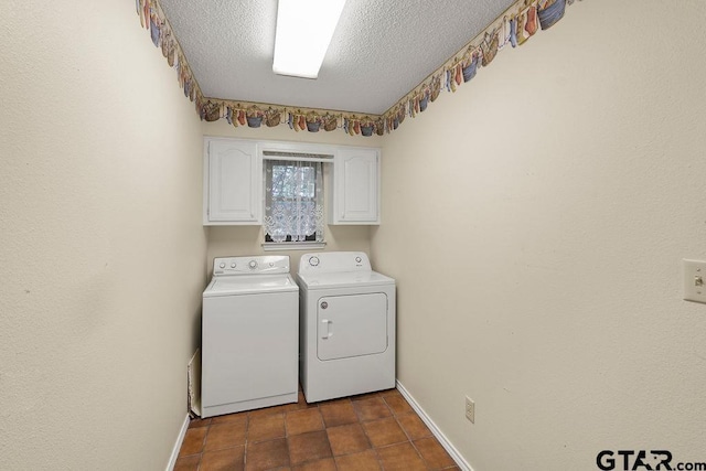 641 Hideaway Ln E, Hideaway, TX 75771 - laundry area with washing machine and clothes dryer, cabinet space, baseboards, a textured ceiling, and dark tile patterned floors