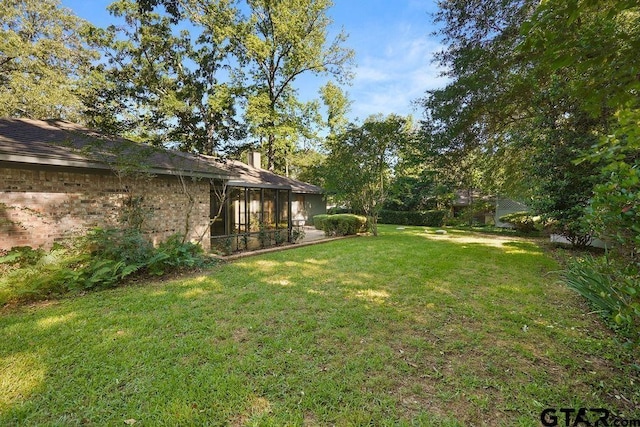 641 Hideaway Ln E, Hideaway, TX 75771 - view of green lawn featuring a lanai