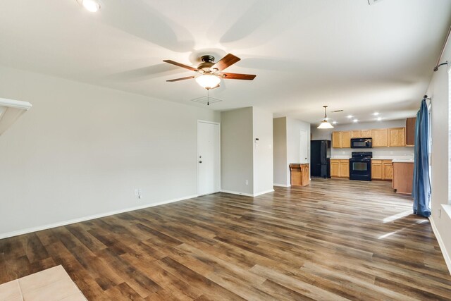 1508 Caymus Ct, Lewisville, TX 75067 - unfurnished living room featuring wood finished floors, a ceiling fan, and baseboards