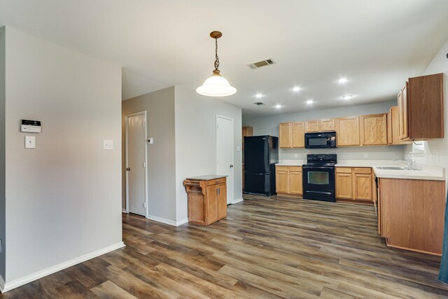 1508 Caymus Ct, Lewisville, TX 75067 - kitchen with black appliances, dark wood-style flooring, baseboards, a sink, and light countertops