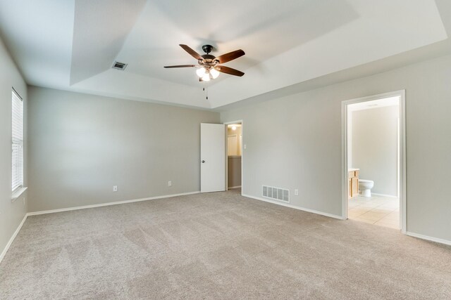 1508 Caymus Ct, Lewisville, TX 75067 - unfurnished bedroom with a tray ceiling, light colored carpet, and baseboards