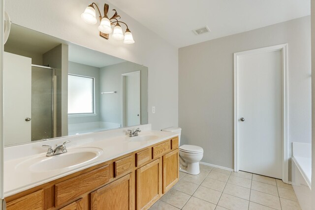 1508 Caymus Ct, Lewisville, TX 75067 - full bathroom featuring a bath, tile patterned flooring, a shower stall, toilet, and double vanity