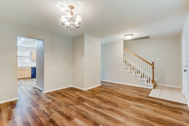 1508 Caymus Ct, Lewisville, TX 75067 - spare room featuring light wood-type flooring, a chandelier, stairway, and baseboards