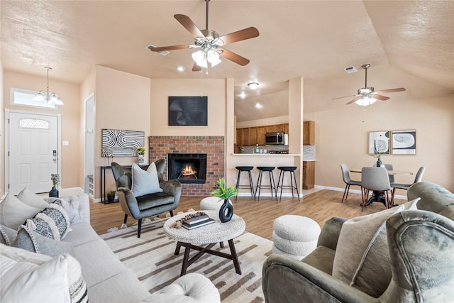 10328 Lone Pine Ln, Fort Worth, TX 76108 - living room with a ceiling fan, light wood-type flooring, baseboards, lofted ceiling, and a textured ceiling
