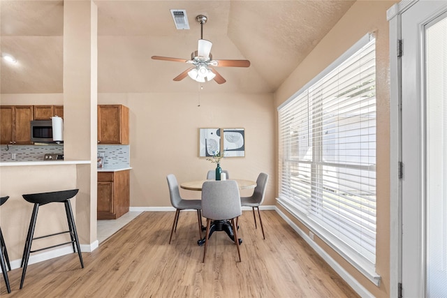 10328 Lone Pine Ln, Fort Worth, TX 76108 - dining space featuring vaulted ceiling, light wood-style floors, ceiling fan, and baseboards