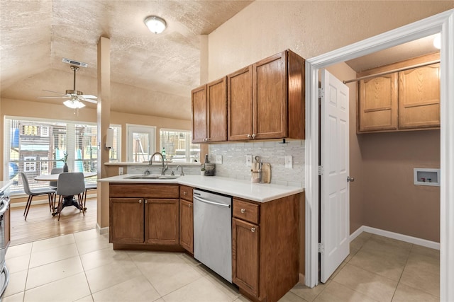 10328 Lone Pine Ln, Fort Worth, TX 76108 - kitchen with a sink, stainless steel dishwasher, ceiling fan, tasteful backsplash, and brown cabinetry