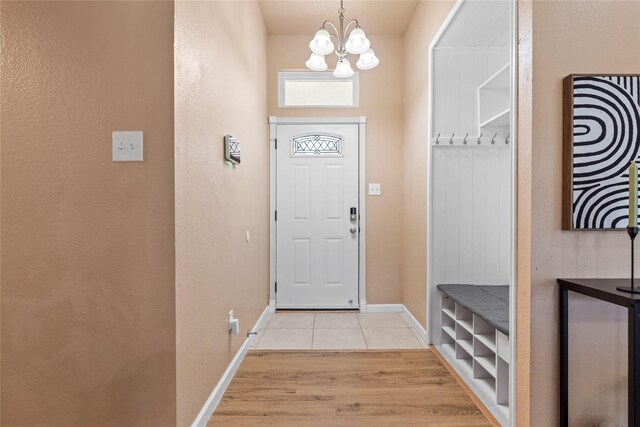 10328 Lone Pine Ln, Fort Worth, TX 76108 - entryway with a chandelier, light wood-style flooring, and baseboards