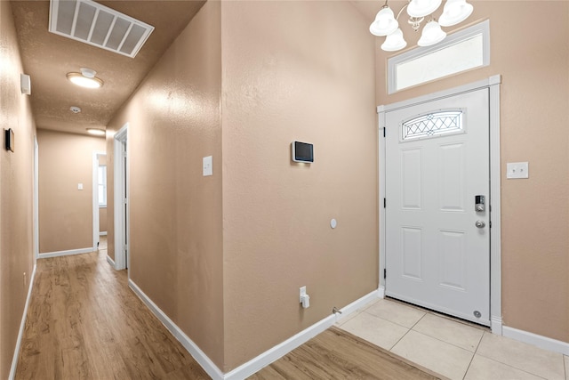 10328 Lone Pine Ln, Fort Worth, TX 76108 - foyer with a chandelier, light wood-style flooring, and baseboards