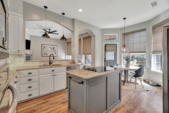 940 Crown Ct, Highland Village, TX 75077 - kitchen with a sink, black electric cooktop, light wood-type flooring, a center island, and recessed lighting