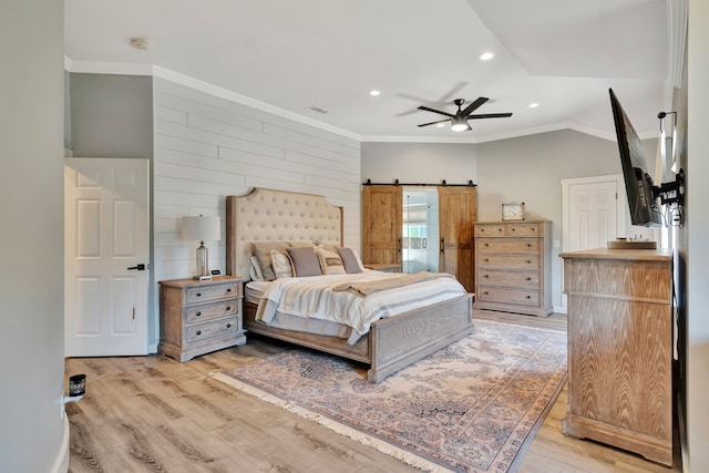 940 Crown Ct, Highland Village, TX 75077 - bedroom featuring light wood-style flooring, a barn door, recessed lighting, vaulted ceiling, and wooden walls