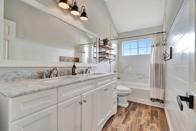 940 Crown Ct, Highland Village, TX 75077 - bathroom featuring double vanity, shower / bath combination with curtain, toilet, wood finished floors, and lofted ceiling