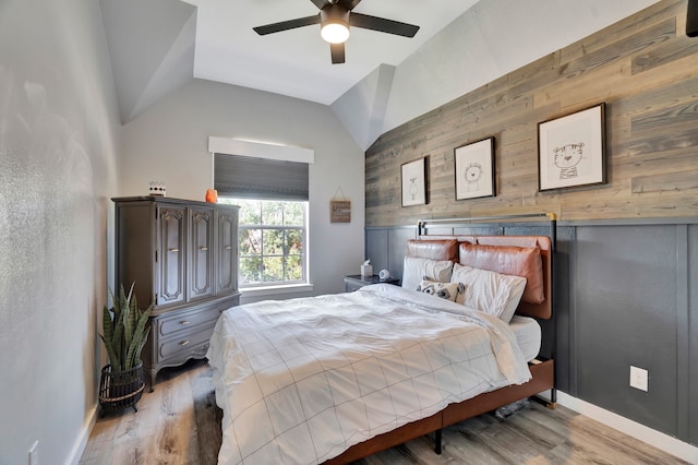 940 Crown Ct, Highland Village, TX 75077 - bedroom with lofted ceiling, wood walls, baseboards, wood finished floors, and a ceiling fan