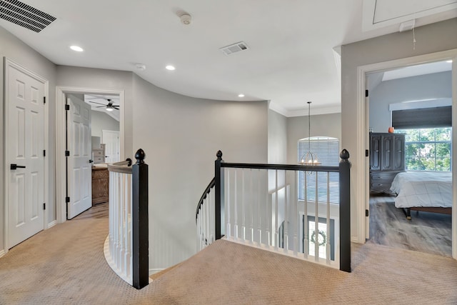 940 Crown Ct, Highland Village, TX 75077 - corridor featuring attic access, an upstairs landing, a chandelier, carpet floors, and recessed lighting