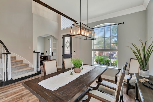940 Crown Ct, Highland Village, TX 75077 - dining area with wood finished floors, arched walkways, baseboards, a chandelier, and ornamental molding