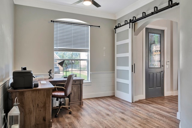 940 Crown Ct, Highland Village, TX 75077 - office with arched walkways, a barn door, light wood finished floors, wainscoting, and a ceiling fan