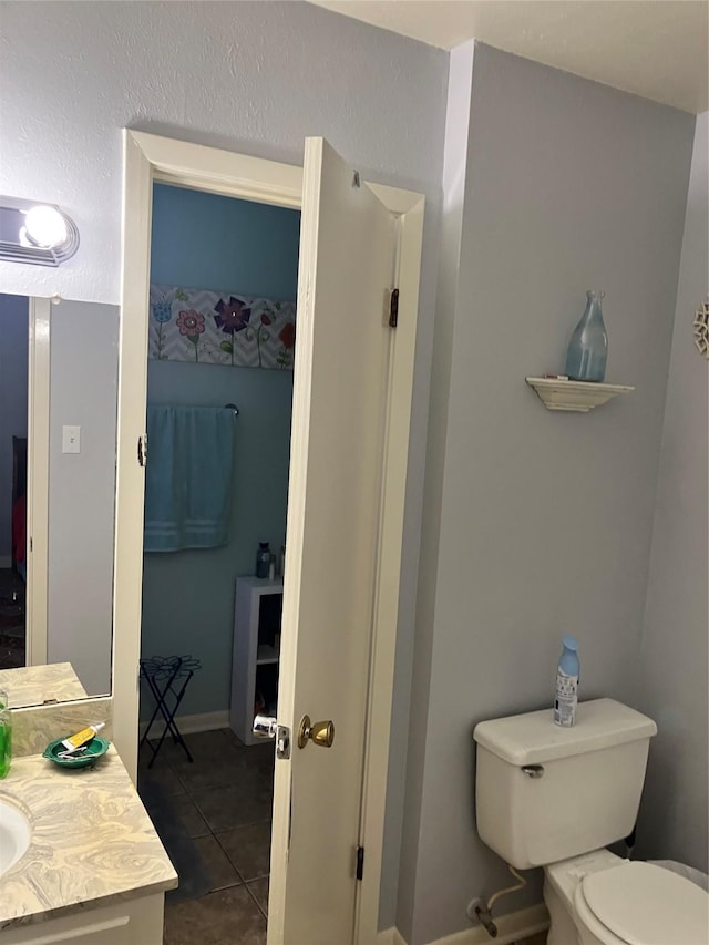 9008 Sara Ln Unit 1, Shreveport, LA 71118 - bathroom featuring tile patterned floors, toilet, vanity, and baseboards