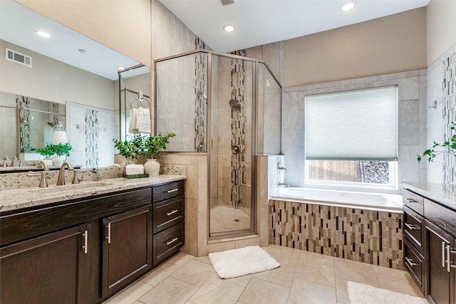 1117 Brandy Sta, Richardson, TX 75080 - bathroom with a stall shower, tile patterned floors, a garden tub, vanity, and recessed lighting