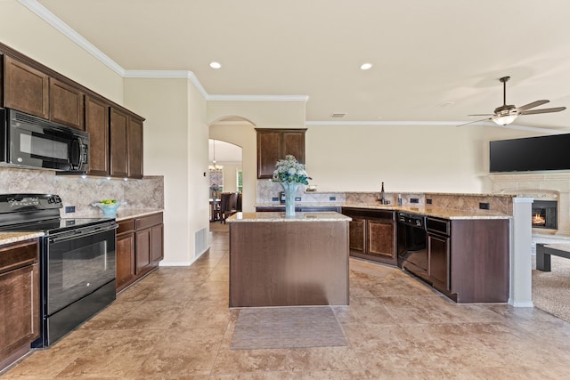 8400 Sioux Trl, Aubrey, TX 76227 - kitchen with black appliances, arched walkways, crown molding, ceiling fan, and tasteful backsplash
