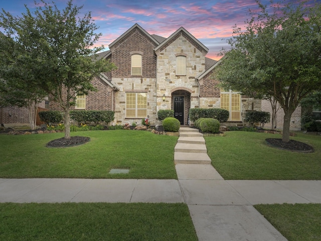 897 Clear Water Dr, Allen, TX 75013 - french country home featuring stone siding, a lawn, and brick siding
