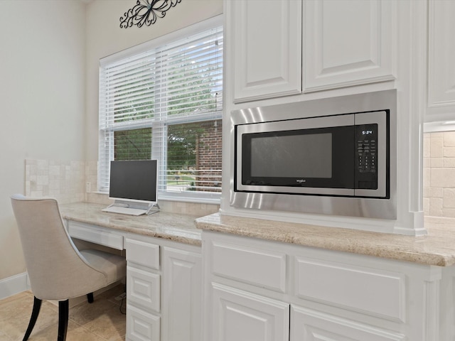 897 Clear Water Dr, Allen, TX 75013 - office area featuring built in desk and light tile patterned floors