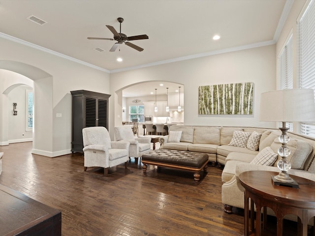 897 Clear Water Dr, Allen, TX 75013 - living room with arched walkways, ceiling fan, wood finished floors, ornamental molding, and baseboards
