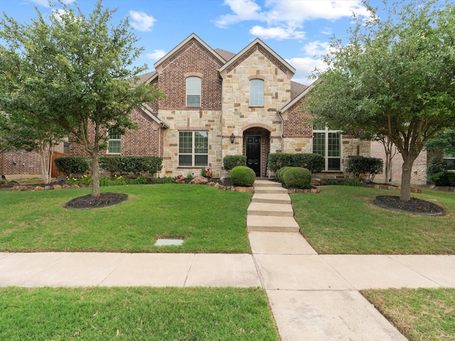 897 Clear Water Dr, Allen, TX 75013 - view of front of home featuring stone siding, a front lawn, and brick siding